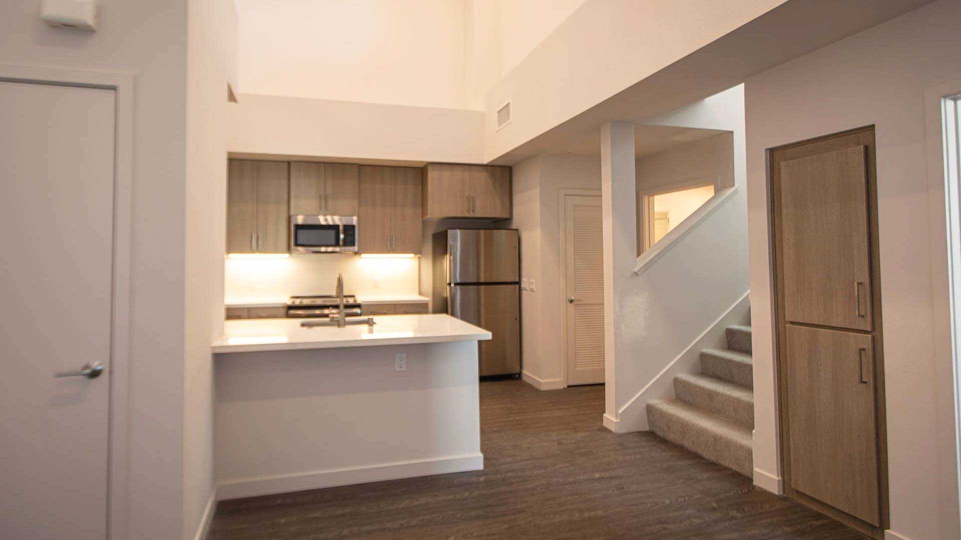 Mira plan H Loft kitchen stairs view 1