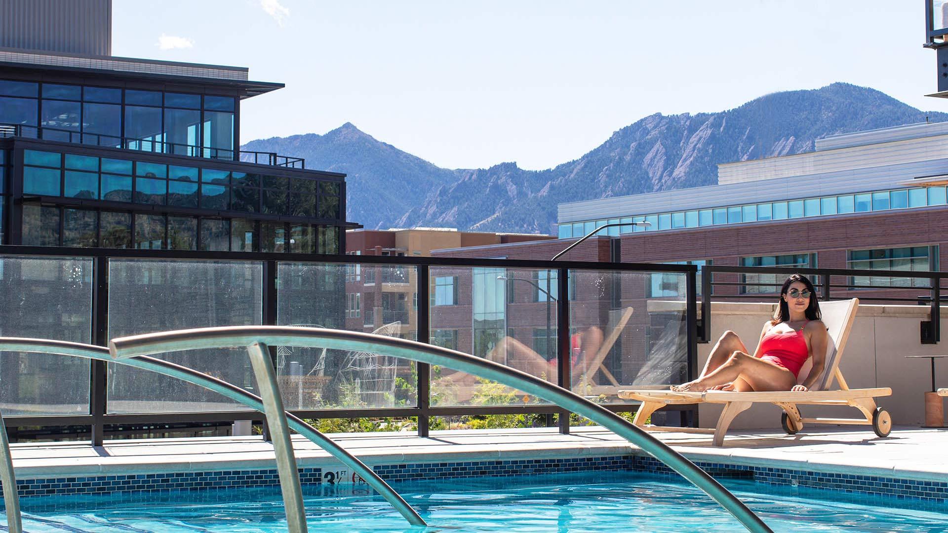 Reve lifestyle woman sunbathing on pool deck